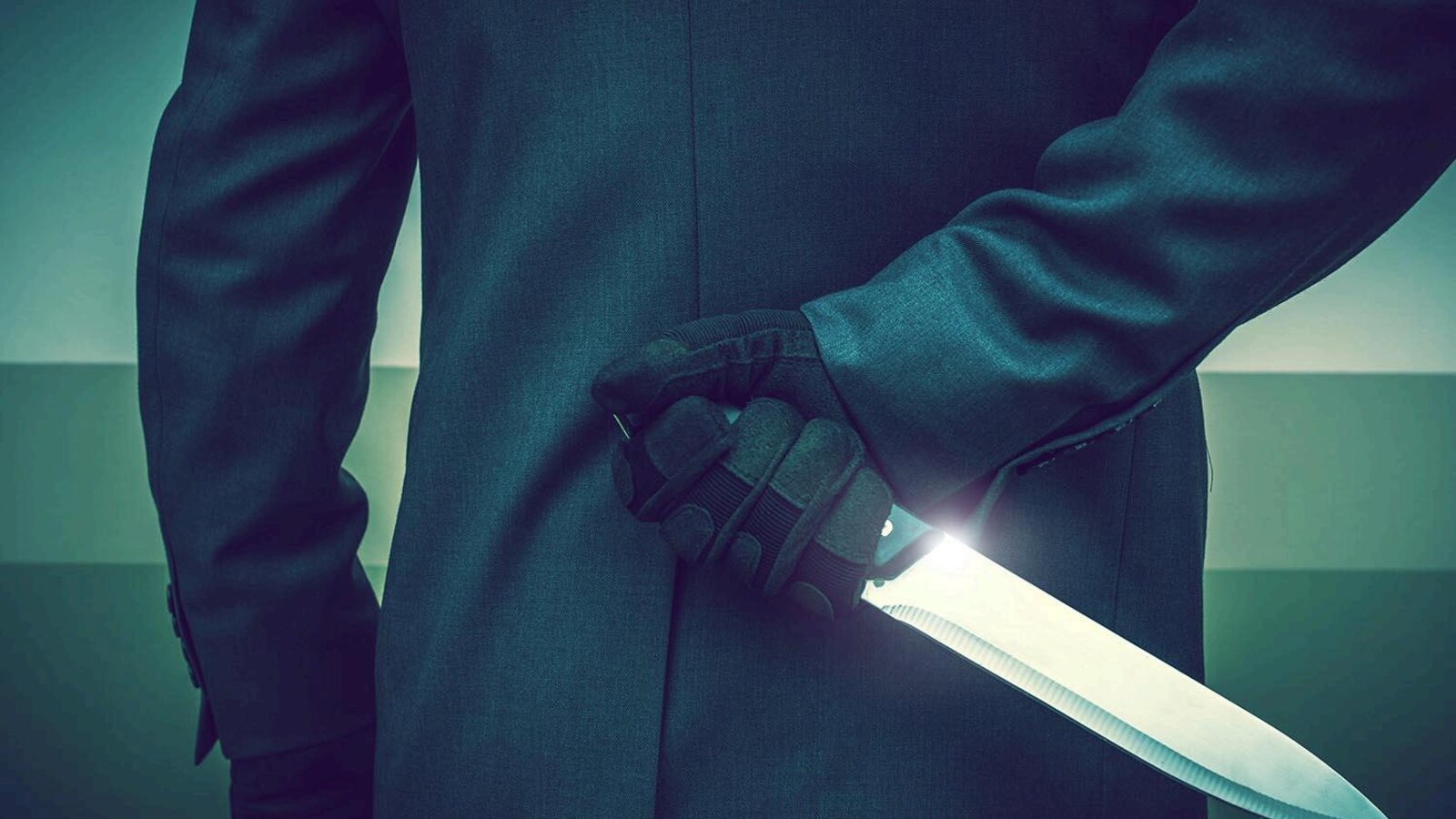 A figure in a suit hiding a knife behind their back, a metaphor for hidden costs cutting into profit.