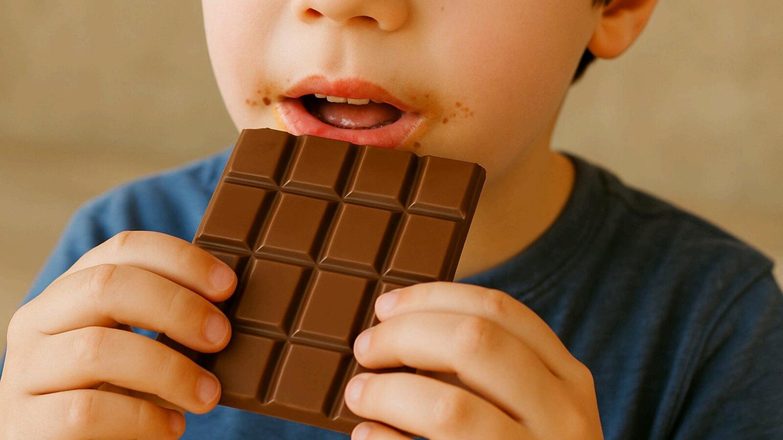 A child eating a chocolate bar, a metaphor for a founder eating into their own profits.