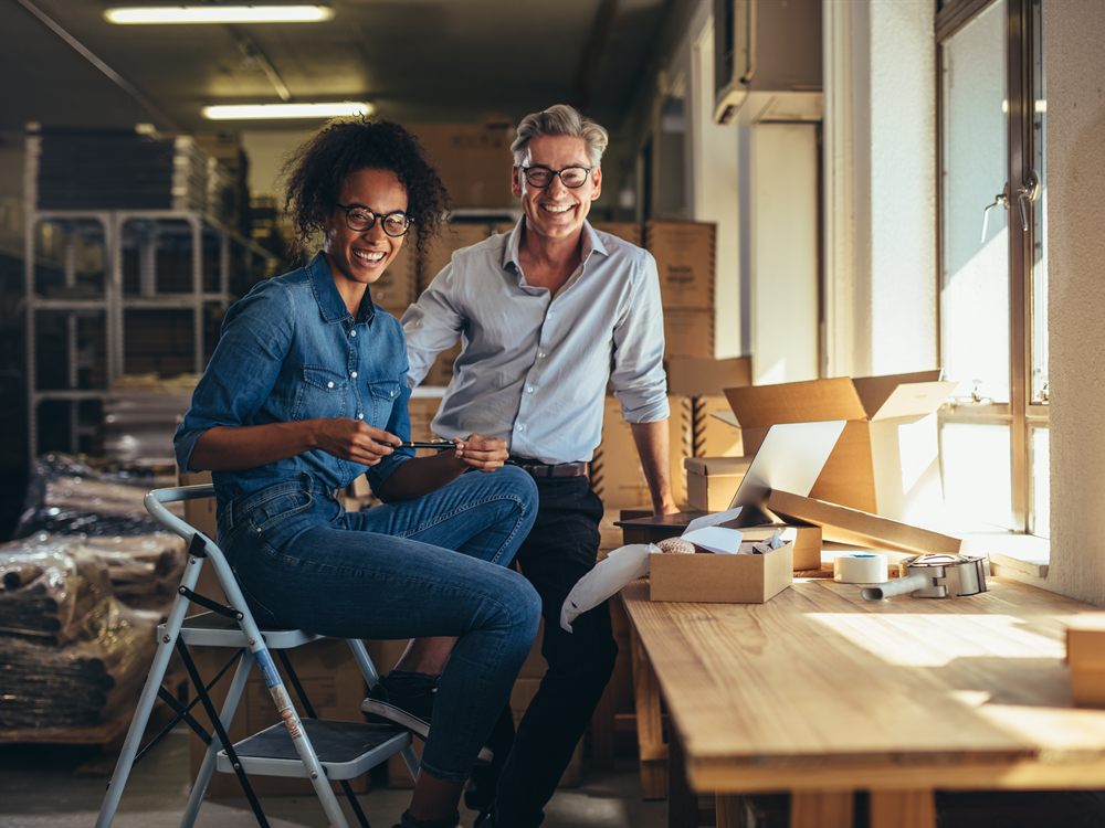 An accountant and a client reviewing figures together at a workspace.